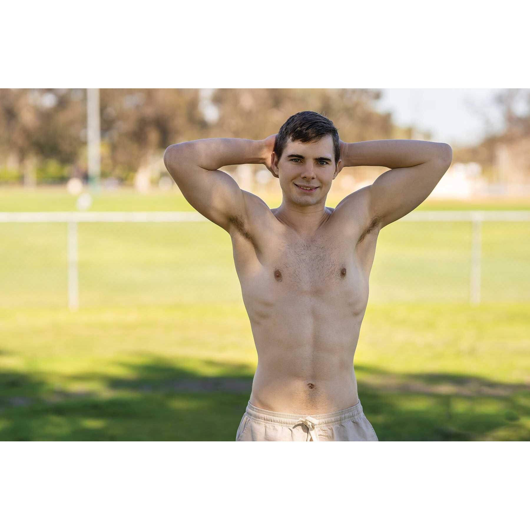 Topless male posed outdoors