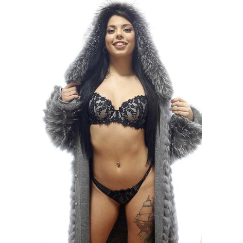 Brunette female posed wearing lingerie displaying cleavage