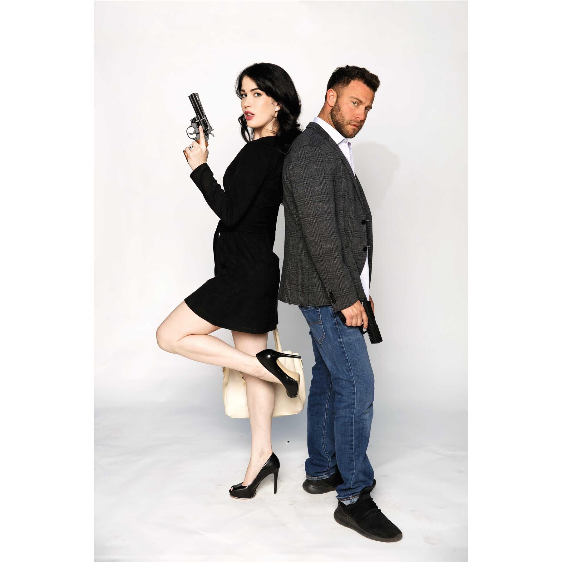 Male female couple posed back to back holding firearms