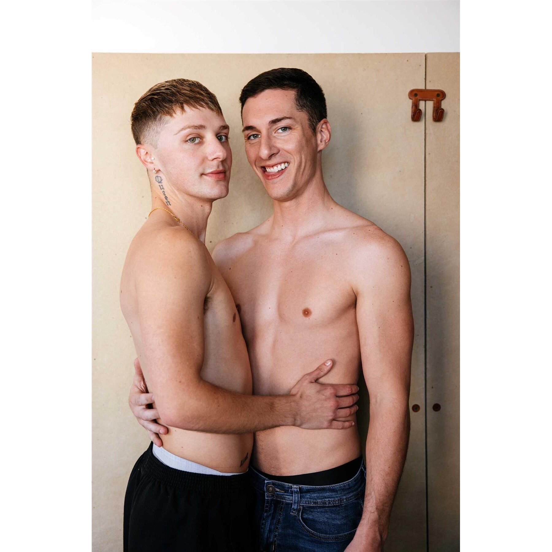 Two topless males posed caressing