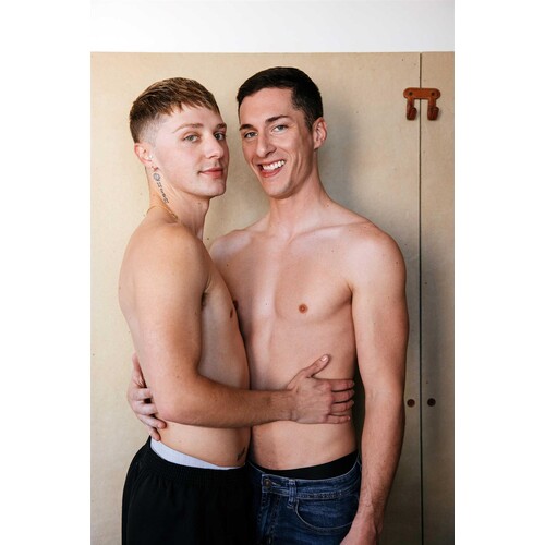Two topless males posed caressing