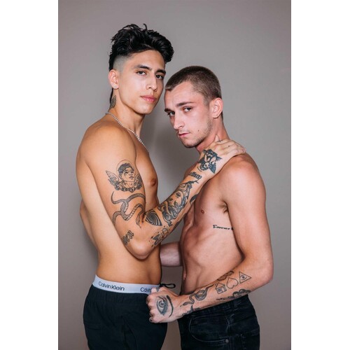 Two topless males caressing