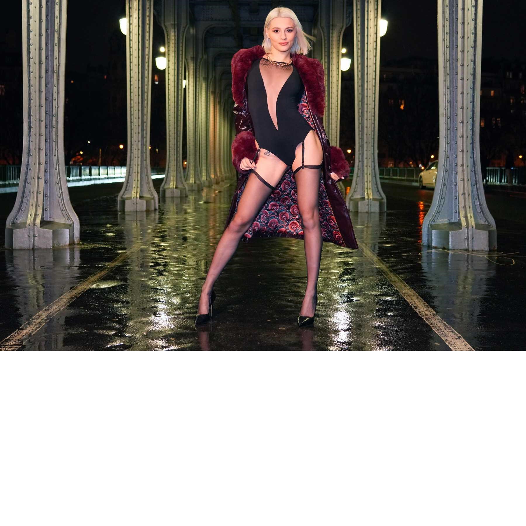 Blonde female posed wearing lingerie outdoors displaying cleavage