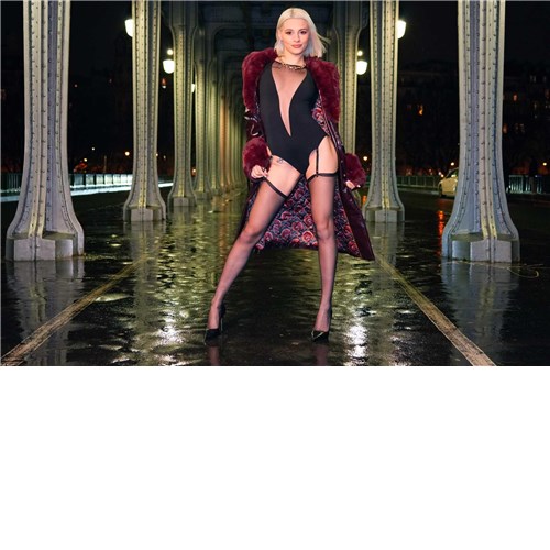 Blonde female posed wearing lingerie outdoors displaying cleavage