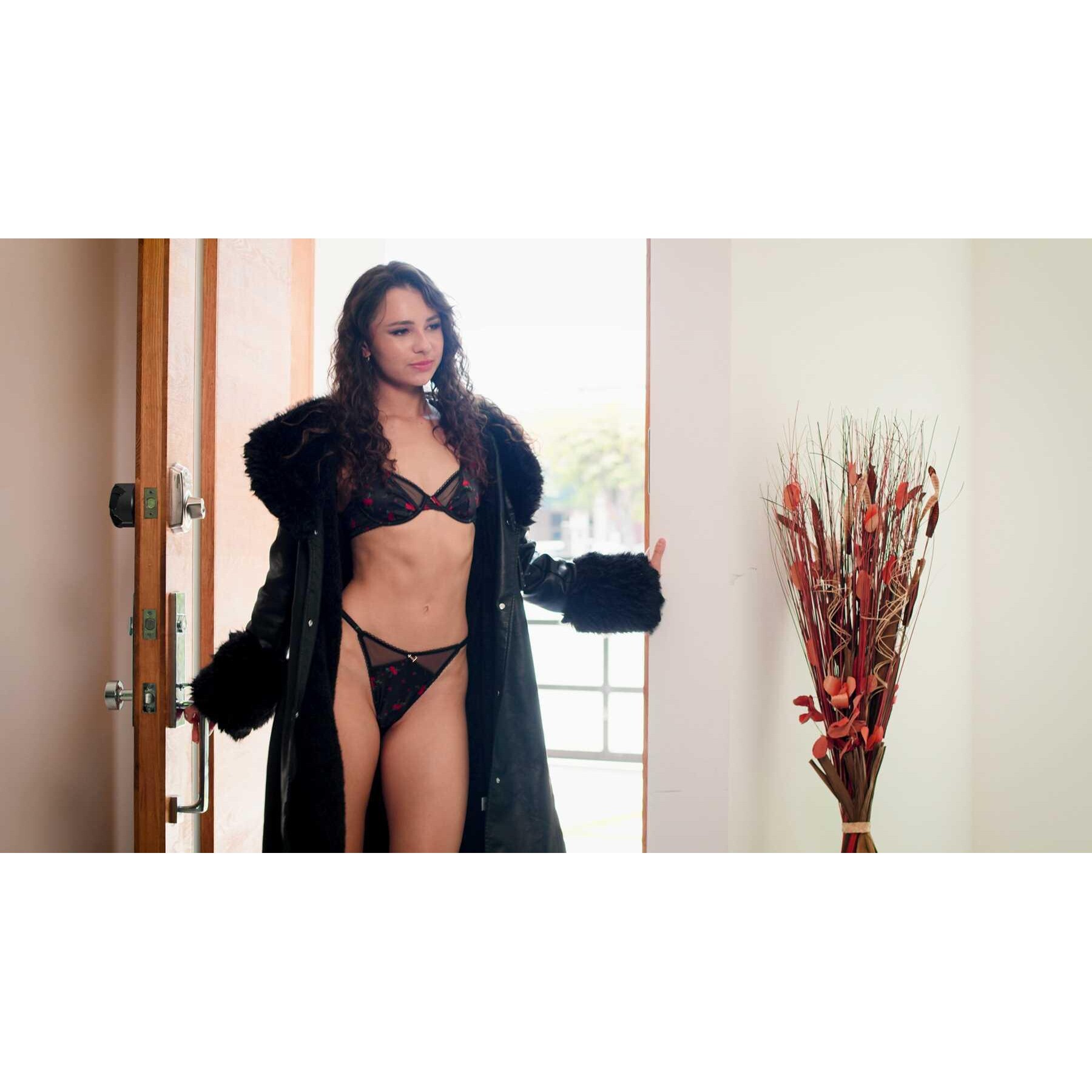 Brunette female wearing robe and lingerie displaying cleavage
